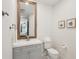 Well-lit bathroom with modern fixtures, including a vanity with storage, a toilet, and decorative wall art at 1876 Livingstone St, Sarasota, FL 34231
