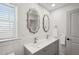 Bathroom features a double sink with vanity, and two decorative mirrors at 1876 Livingstone St, Sarasota, FL 34231