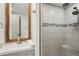 Updated bathroom featuring a wooden-framed mirror, modern vanity, and tiled walk-in shower with bench seating at 1876 Livingstone St, Sarasota, FL 34231