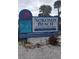 Sign for Nokomis Beach, highlighting its recreational amenities, and county-operated status near native landscaping at 1876 Livingstone St, Sarasota, FL 34231