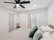 Bedroom with light walls, wood floor, ceiling fan and small decorative chair at 1876 Livingstone St, Sarasota, FL 34231