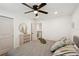 Bedroom with light walls, wood floor, ceiling fan, and decorative chest at 1876 Livingstone St, Sarasota, FL 34231