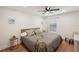Bedroom with light walls, wood floor, ceiling fan, and many decorative pillows at 1876 Livingstone St, Sarasota, FL 34231