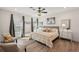 Cozy bedroom with many windows, wood floors, ceiling fan, and plenty of sunlight at 1876 Livingstone St, Sarasota, FL 34231