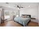 Cozy bedroom with a comfortable bed, ceiling fan, and dresser with a decorative mirror at 1876 Livingstone St, Sarasota, FL 34231