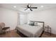 Bedroom features light walls, wood floor, a ceiling fan, and simple decor at 1876 Livingstone St, Sarasota, FL 34231