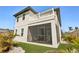 Rear exterior showing a balcony, screened porch, synthetic grass, and easy-care landscaping, enhancing outdoor living at 1876 Livingstone St, Sarasota, FL 34231