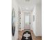 Bright hallway with a decorative runner rug, leading to a glass-paneled front door at 1876 Livingstone St, Sarasota, FL 34231
