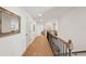 Upstairs hallway featuring hardwood floors, white walls, and black metal railing at 1876 Livingstone St, Sarasota, FL 34231