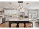 Modern kitchen featuring white cabinets, stainless steel appliances, and a large center island at 1876 Livingstone St, Sarasota, FL 34231