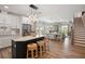 Open concept kitchen with white cabinets, stainless steel appliances, and breakfast bar seating at 1876 Livingstone St, Sarasota, FL 34231