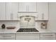 Gourmet kitchen with granite countertops, stainless steel appliances, and white cabinetry at 1876 Livingstone St, Sarasota, FL 34231
