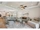 Spacious living room featuring a large sectional sofa, ceiling fan, and open layout at 1876 Livingstone St, Sarasota, FL 34231