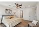 Comfortable main bedroom with a ceiling fan, wood-look floors, and an ensuite bathroom for added convenience at 1876 Livingstone St, Sarasota, FL 34231