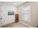 Office features light walls, wood floor, window, and decorative shelf with books at 1876 Livingstone St, Sarasota, FL 34231