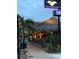 View of outdoor dining under a thatched roof with string lights at 1876 Livingstone St, Sarasota, FL 34231
