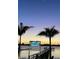Waterfront restaurant sign at dusk with palm trees and pier visible at 1876 Livingstone St, Sarasota, FL 34231