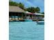 Bright waterfront with boating docks, watercraft, thatched roofs, and tropical foliage at 1876 Livingstone St, Sarasota, FL 34231