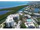 Aerial view of condo community with pool, waterway and Gulf views at 1930 Harbourside Dr # 136, Longboat Key, FL 34228
