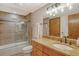 Bathroom with granite countertop, wood cabinets, shower, and glass doors at 1930 Harbourside Dr # 136, Longboat Key, FL 34228