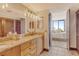 Bathroom with double vanity and a view into the bedroom at 1930 Harbourside Dr # 136, Longboat Key, FL 34228