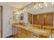 Bathroom featuring double vanity with granite countertop and decorative lighting at 1930 Harbourside Dr # 136, Longboat Key, FL 34228