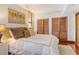 Bedroom with wooden floors, natural light, and wooden closets at 1930 Harbourside Dr # 136, Longboat Key, FL 34228