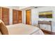 Bedroom with wood-look floors, two closets and TV on the wall at 1930 Harbourside Dr # 136, Longboat Key, FL 34228