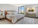 Bright bedroom with large window and neutral decor at 1930 Harbourside Dr # 136, Longboat Key, FL 34228