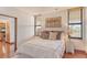 Bright bedroom features wood floors, neutral walls, art and two windows at 1930 Harbourside Dr # 136, Longboat Key, FL 34228
