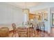 Bright dining area featuring a glass table, stylish wicker chairs, and an open view to the kitchen at 1930 Harbourside Dr # 136, Longboat Key, FL 34228