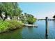 Community dock with access to the water, surrounded by lush greenery and landscaping at 1930 Harbourside Dr # 136, Longboat Key, FL 34228