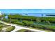 Scenic view of the landscaping with lush green trees and plants with a beautiful body of water in the background at 1930 Harbourside Dr # 136, Longboat Key, FL 34228