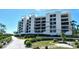 Low-rise condo community features private balconies and lush tropical landscaping at 1930 Harbourside Dr # 136, Longboat Key, FL 34228