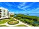 Exterior view of the condo buildings showcasing the beautiful landscaping and waterfront views at 1930 Harbourside Dr # 136, Longboat Key, FL 34228