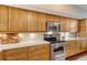 Close up of modern kitchen with stainless steel appliances and light wood cabinets at 1930 Harbourside Dr # 136, Longboat Key, FL 34228