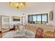 Bright living room with hardwood floors, comfortable seating, and sliding glass doors to the balcony at 1930 Harbourside Dr # 136, Longboat Key, FL 34228