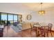 Cozy living room featuring a comfortable couch, a glass dining table, and a scenic view of the water at 1930 Harbourside Dr # 136, Longboat Key, FL 34228