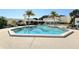 Stunning geometric pool surrounded by lounge chairs and tropical landscaping, offering a serene retreat at 1930 Harbourside Dr # 136, Longboat Key, FL 34228