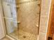 Tiled shower with glass door and built-in shelves at 1930 Harbourside Dr # 136, Longboat Key, FL 34228