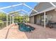 Enclosed pool area with brick patio, seating, and clear blue sky at 2408 89Th Nw St, Bradenton, FL 34209