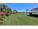 Beautiful backyard with lush green lawn, lake view, manicured landscaping, and serene outdoor ambiance at 2512 61St E Ave, Ellenton, FL 34222
