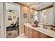 Bathroom with double vanity, large mirror, and a glimpse into the adjacent room at 2512 61St E Ave, Ellenton, FL 34222