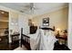 Inviting bedroom featuring a dark wood bed with plush white bedding, bedside tables, and decorative accents at 2512 61St E Ave, Ellenton, FL 34222