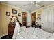 Cozy bedroom featuring a bed with white linen, wooden dresser, and decor at 2512 61St E Ave, Ellenton, FL 34222