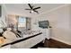 Bright bedroom featuring a bed with patterned throw pillows, and TV on dresser at 2512 61St E Ave, Ellenton, FL 34222