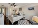 Bedroom with bed featuring patterned throw pillows, side table, and hardwood floors at 2512 61St E Ave, Ellenton, FL 34222