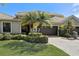Inviting home showcasing well-maintained landscaping, a paver driveway, and a neutral color palette under a clear blue sky at 2512 61St E Ave, Ellenton, FL 34222