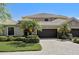 Beautiful home with paver driveway, two-car garage, lush landscaping, and charming curb appeal at 2512 61St E Ave, Ellenton, FL 34222