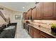 Open-concept kitchen with stainless steel appliances, granite countertops, and wood cabinets at 2512 61St E Ave, Ellenton, FL 34222